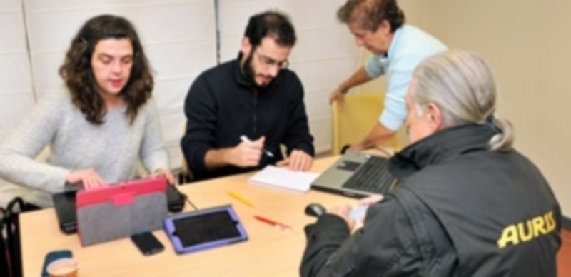 Miembros del Consejo Ciudadano Municipal de Podemos Segovia atienden a un votante en la cosulta. / JUAN MARTÍN