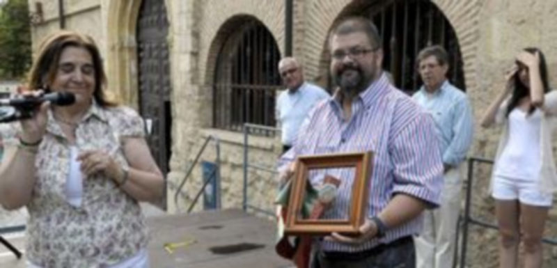 Marcelo Galindo recibe un regalo por parte de la presidenta de la Asociación de Vecinos. / ALBERTO BENAVENTE