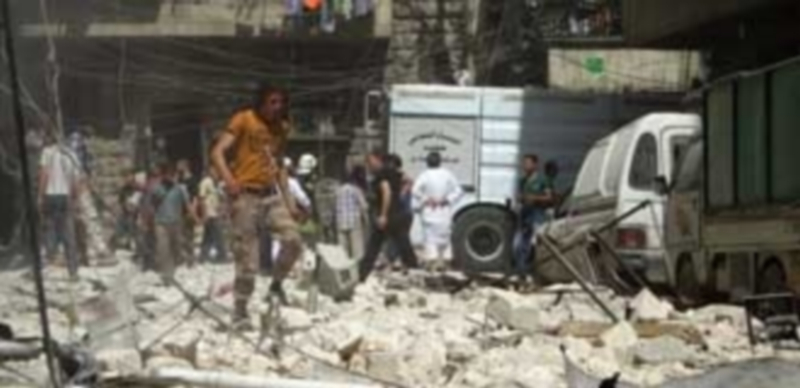 Varias personas se reúnen en el lugar de los ataques aéreos perpetrados el jueves contra un hospital de Alepo. / EFE