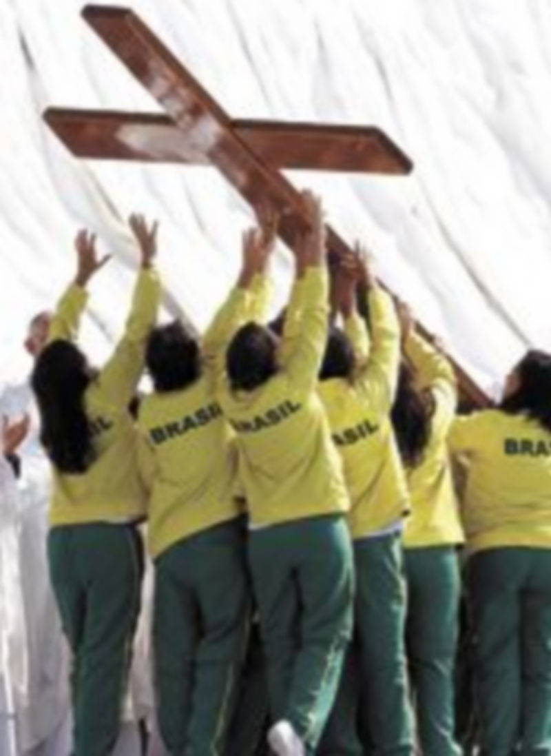 Jóvenes de Brasil elevan la cruz que regaló en 1982 Juan Pablo II a los jóvenes para que presidiera todas las JMJ. / Reuters