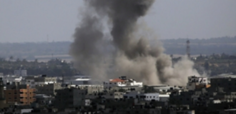 Una columna de humo se desprende de un edificio en Gaza