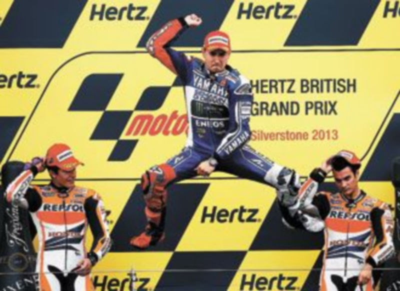 Lorenzo muestra su alegría en el podio acompañado por Márquez (i) y Pedrosa. / Reuters