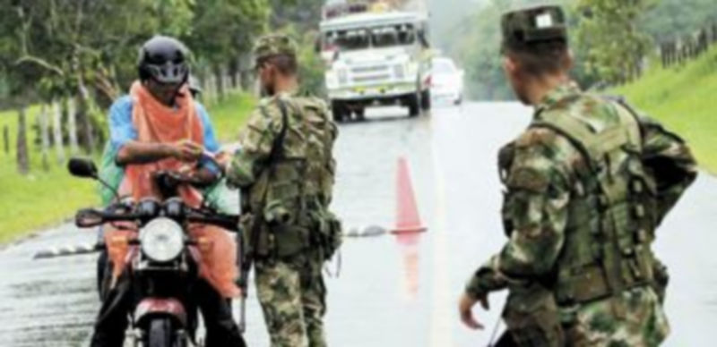 Un soldado colombiano le pide a un motorista su licencia y documentos en una zona de alta actividad de las FARC. / Reuters