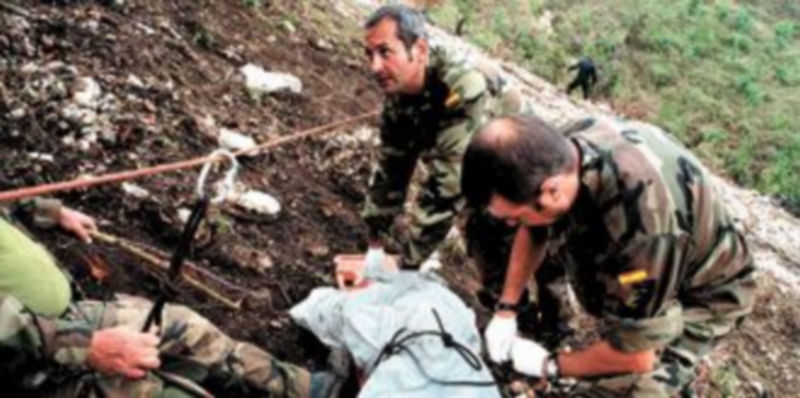 Efectivos del equipo de rescate cubren los cuerpos sin vida de los militares antes de trasladarlos al buque ‘Castilla’. / Efe