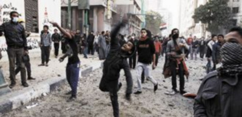 Varios manifestantes lanzan piedras contra los agentes de la Policía desplegados en la Plaza de Tahrir de la capital egipcia. / Reuters