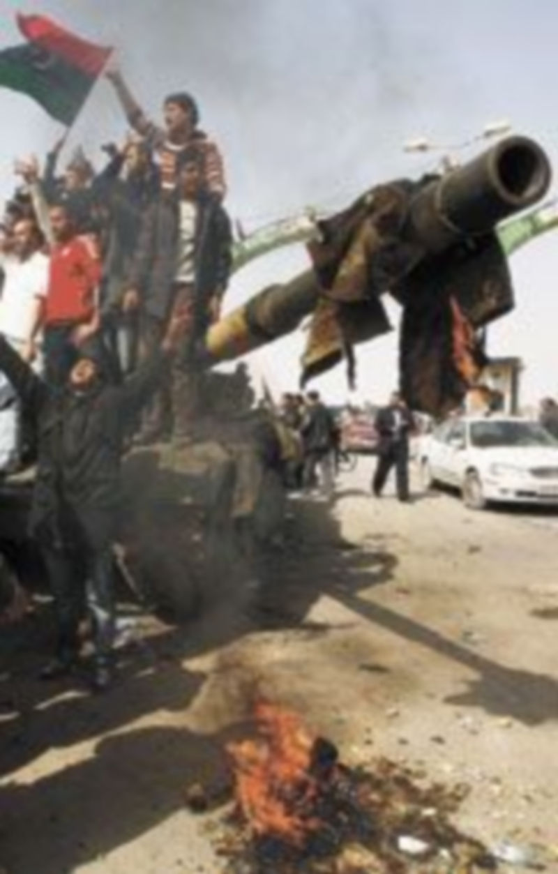 Las fuerzas insurgentes celebran la ‘reconquista’ de Ajdabiya con la quema de una fotografía de Gadafi. / Reuters.
