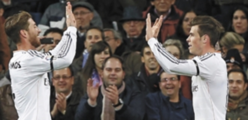 El centrocampista galés del Real Madrid Gareth Bale celebra con su compañero Sergio Ramos el primer gol que marcó ante el Valladolid. / Efe