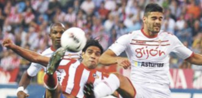 El colombiano Falcao intenta rematar ante la oposición de Botía. / Efe.