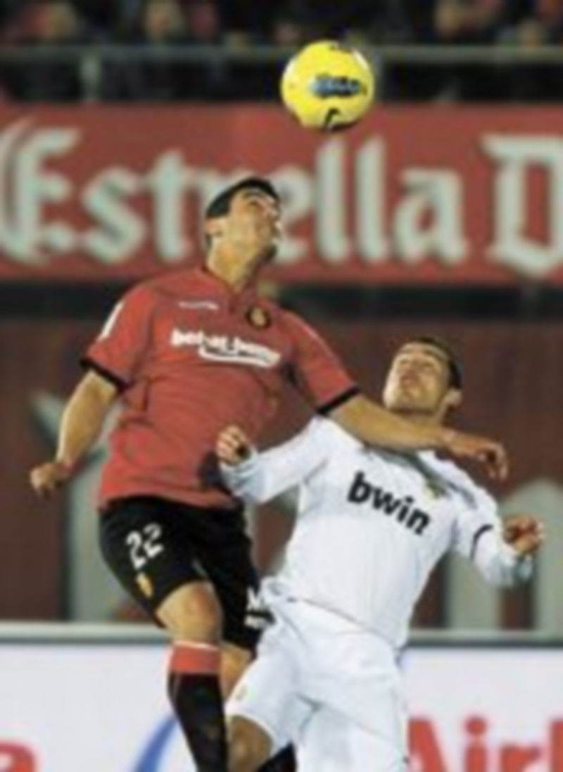 Cristiano Ronaldo pelea por un balón aéreo con Pau Cendrós.