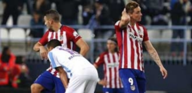 Tropiezo y sin liderato 1 Fernando Torres (derecha) y Koke se lamentan tras el gol de Charles que supuso la derrota del Atlético en La Rosaleda. / EFE