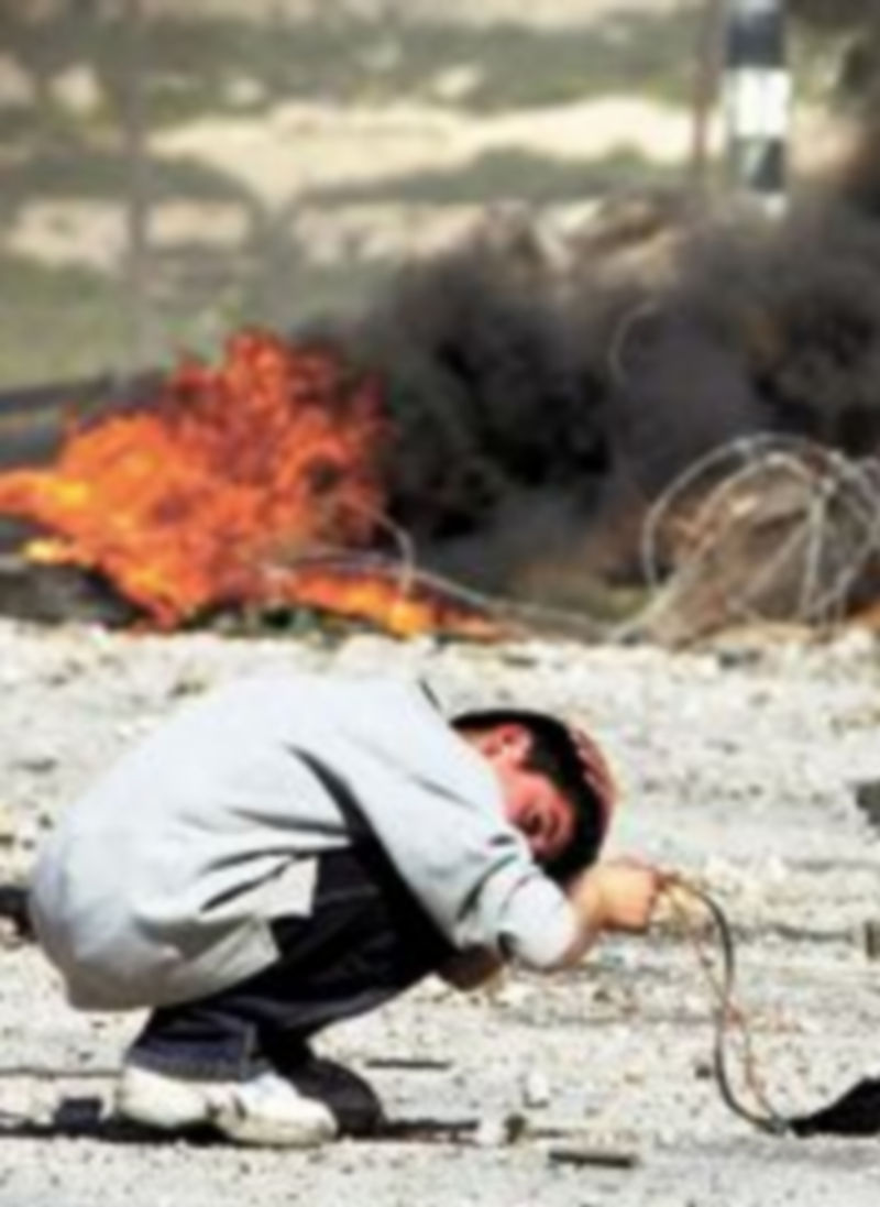 Un niño palestino se protege de ataques israelíes. / Nasser (AP)