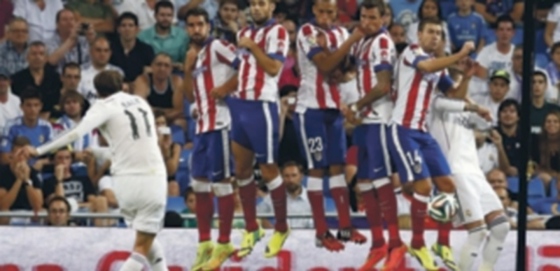 Bale ejecuta una falta ante la barrera compuesta por Raúl García