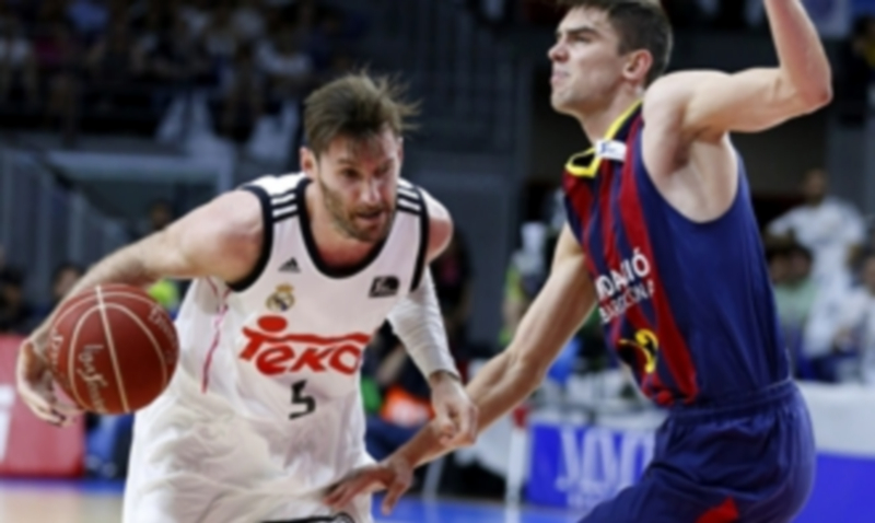 El alero madridista Rudy Fernández (i) encara al base culé Tomas Satoransky. / EFE