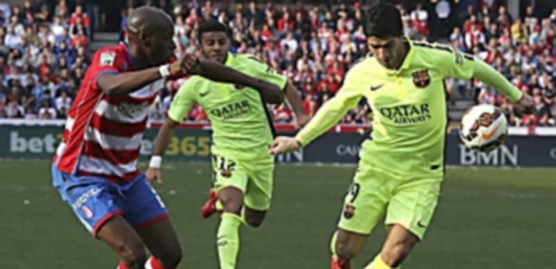 Luis Suárez (derecha) controla el balón ante Allan Nyom durante el partido liguero del FC Barcelona ante el Granada. / EFE