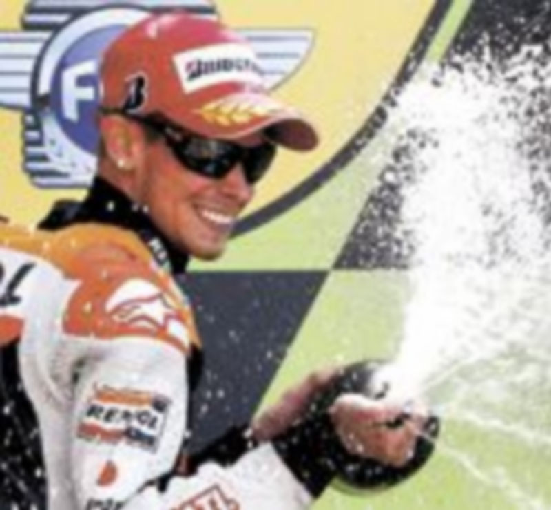 Casey Stoner festeja su victoria en la categoría reina por delante de Andrea Dovizioso y Valentino Rossi. / Reuters
