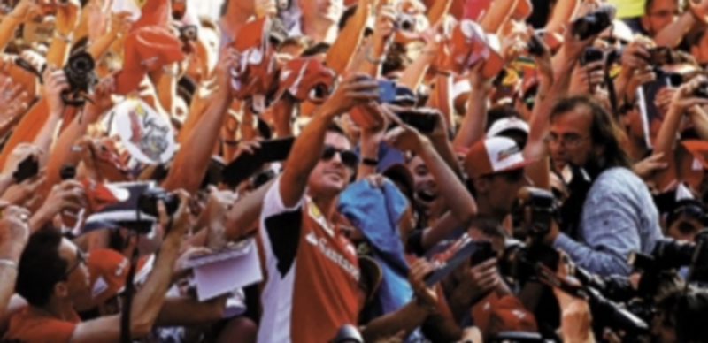 El piloto asturiano hizo las delicias de los aficionados al firmar autógrafos y fotografiarse con ellos. / Alberto Estévez (efe)