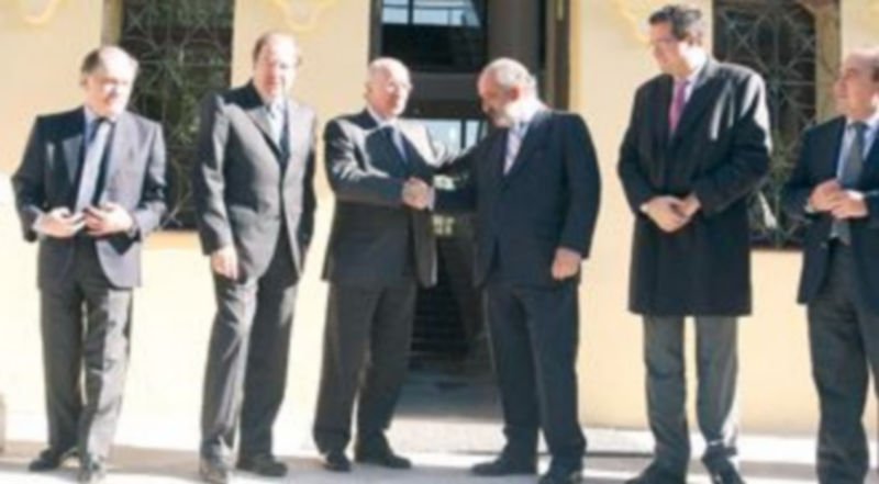 Julio Fermoso (3i) y Santos Llamas estrechan sus manos en presencia de Tomás Villanueva (i)