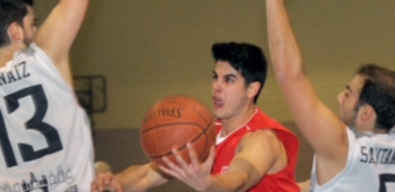 El base segoviano Fernando Yagüe penetra a canasta entre dos rivales. / Kamarero