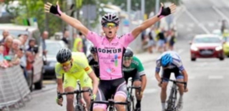 El ciclista del sub 23 del Gomur-Liébana 2017 José Antonio García cruza la línea de meta en primera posición en un final de etapa definido al sprint. / KAMARERO