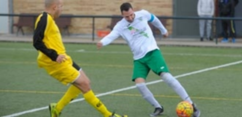 El jugador del CD Quintanar intenta evitar el centro de su rival del CD San Lorenzo. / KAMARERO