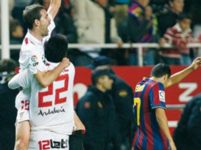 Navarro y Romaric celebran el pase del Sevilla ante la desolación del azulgrana Pedro. / EFE