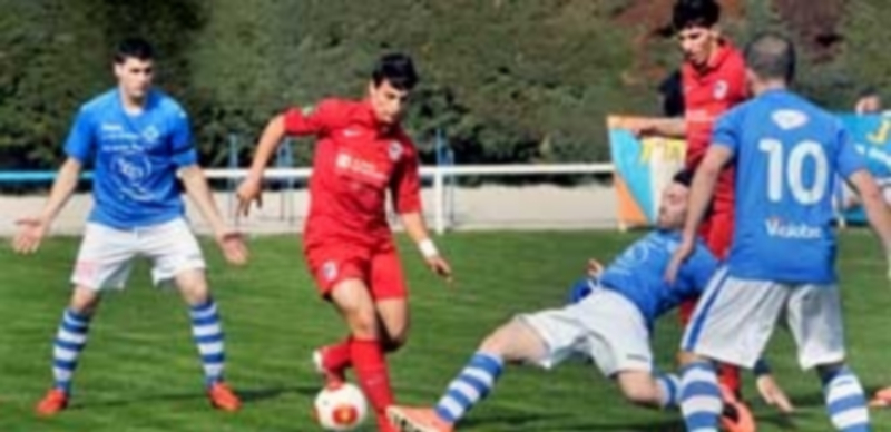 Otero se lanza al suelo para cortar el avance de un jugador del Santa Marta durante la primera parte del encuentro que disputó el equipo granjeño frente al salmantino en El Hospital. / Kamarero