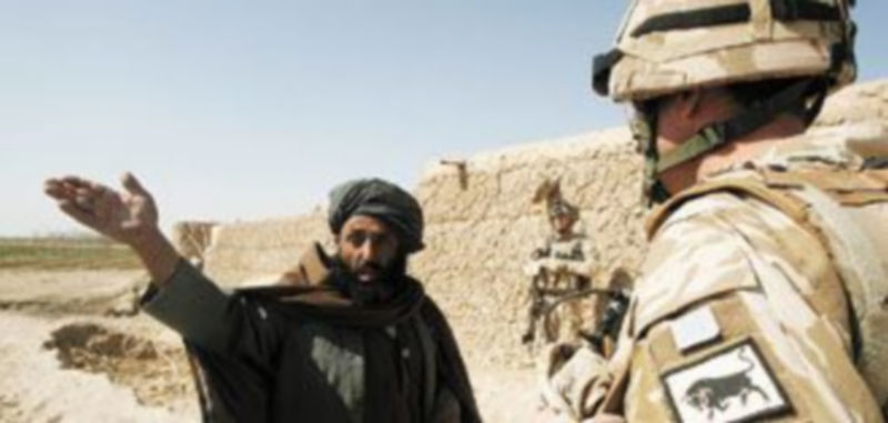 Un coronel británico del cuerpo de ingenieros habla con un granjero afgano en las inmediaciones de la ciudad de Nad Alí. / Reuters