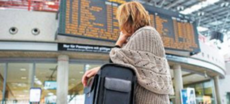 Una pasajera observa los paneles electrónicos del aeropuerto germano de Stuttgart donde se cancelaron casi todos los vuelos. / UWE ANSPACH (Efe)