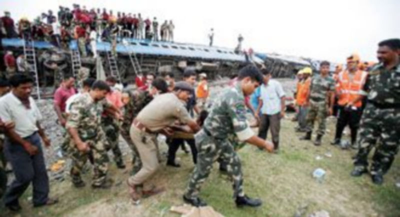 Soldados y miembros de los equipos de rescate trasladan a uno de los heridos en el desastre ferroviario acontecido ayer en Bengala. / Parth Sanyal (Reuters)