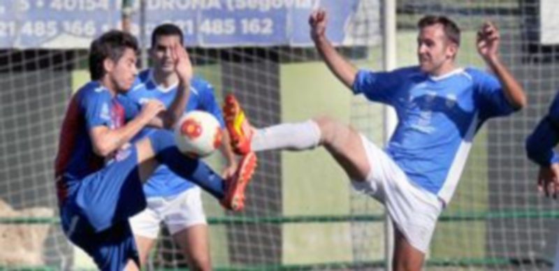 Dani Calleja y Chechu levantan la pierna intentando hacerse con el control de la pelota en un momento del partido jugado en la mañana del domingo en La Albuera. / Kamarero