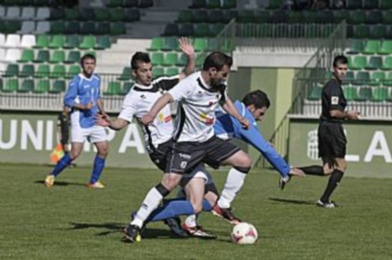 Juanlu cae ante la entrada de dos jugadores del Burgos en un momento del partido. / Juan Martín