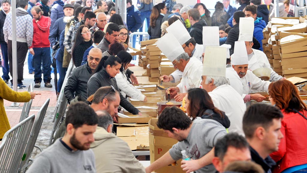 Vecinos y visitantes hicieron cola para participar en la degustación popular de garbanzos con chorizo. / kamarero