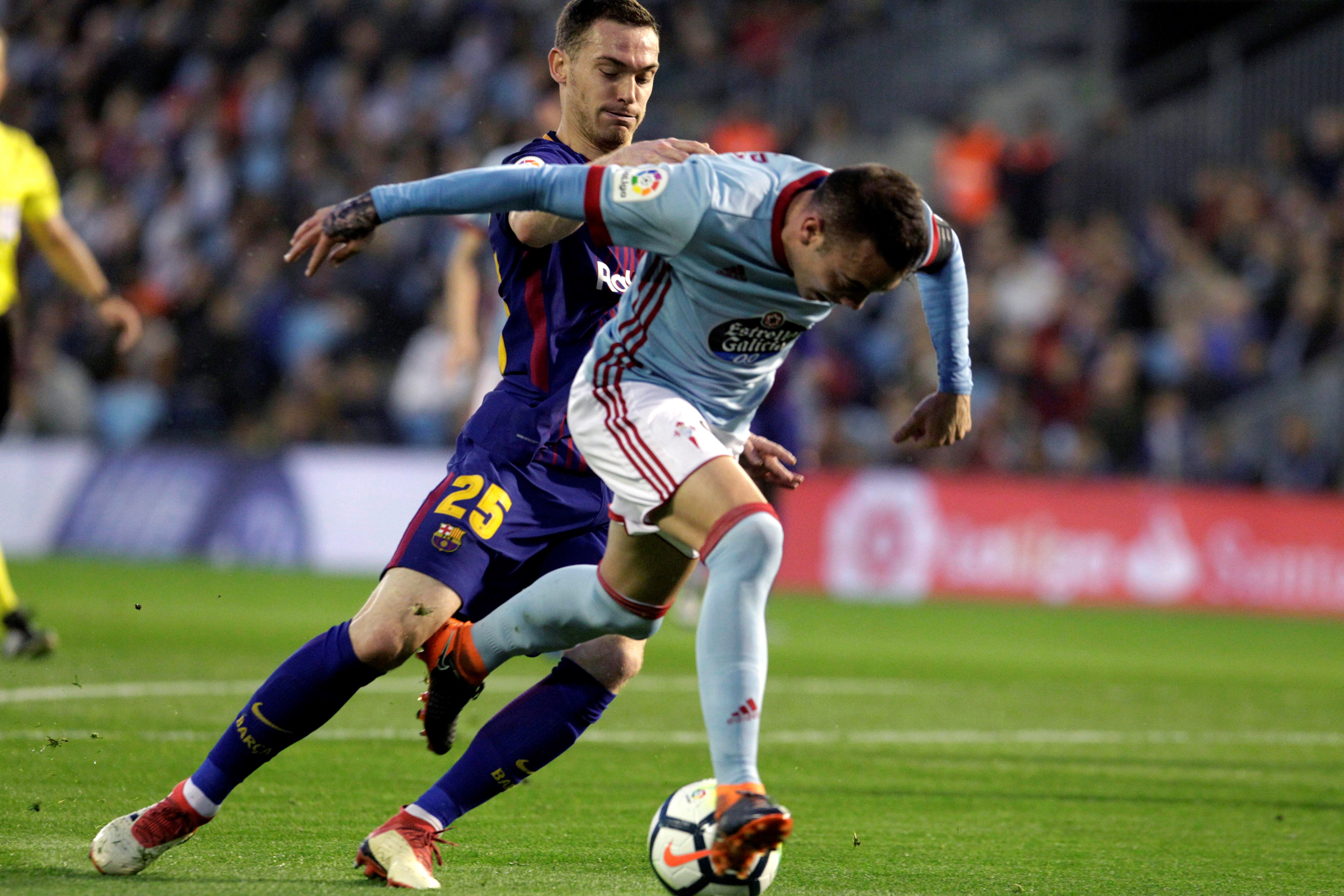 El defensa belga del Barcelona Thomas Vermaelen (i) pelea un balón con el delantero del Celta Iago Aspas.
