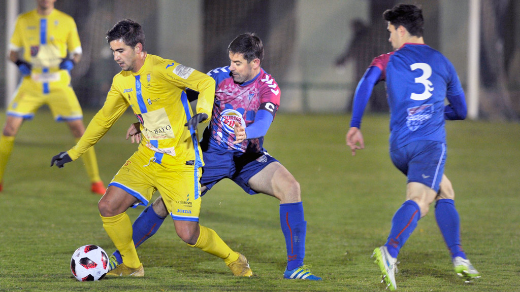 El capitán de la Gimnástica Segoviana, Anel, trata de robar un balón a un contrincante de la Arandina CF. / KAMARERO