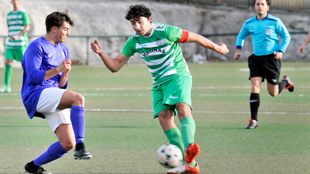 El jugador del CD Cantimpalos intenta el regate sobre su rival del Monteresma en el partido jugado en el campo de La Mina. / KAMARERO