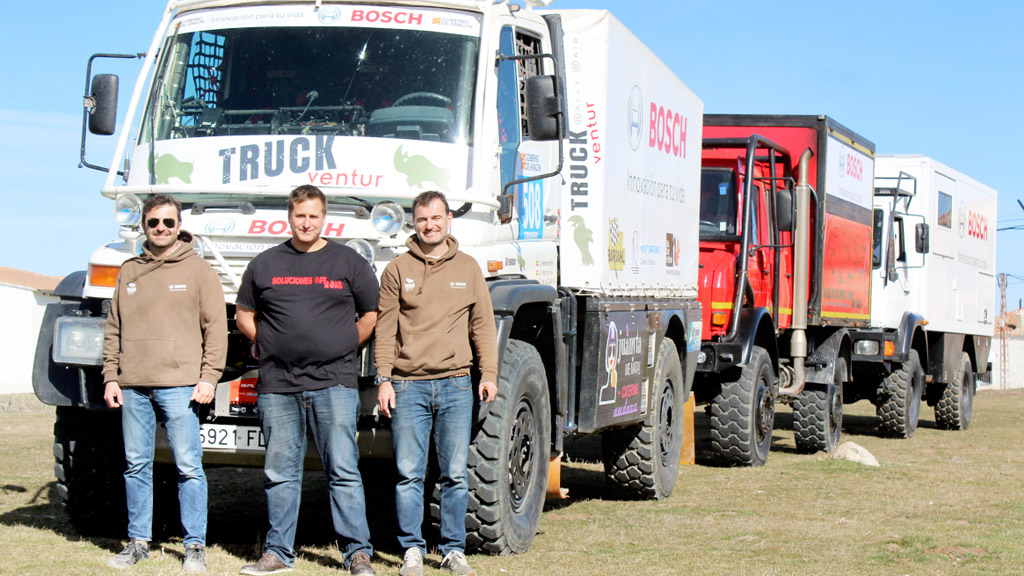 El equipo formado por los segovianos, junto al camión Unimog con el que competirán, y los vehículos de apoyo. / e. A.