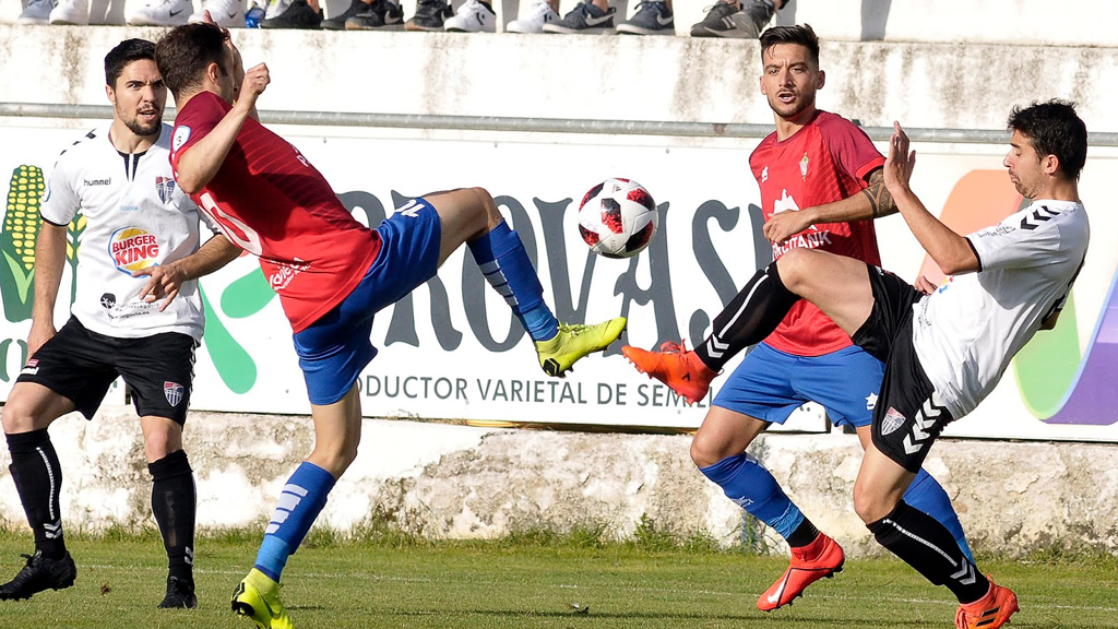El centrocampista de la Gimnástica Segoviana Joaquín Martín ‘Quino’ y un contrincante del CP Villarrobledo intentan bajar un balón en un trance del juego. / JUAN MARTÍN - LA GIMNÁSTICA