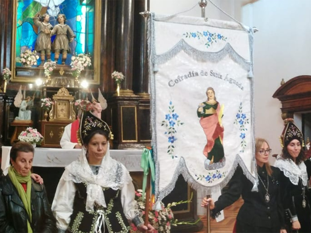 Las alcaldesas y mayordomas del año pasado posan junto al estandarte de Santa Águeda. / E.A.