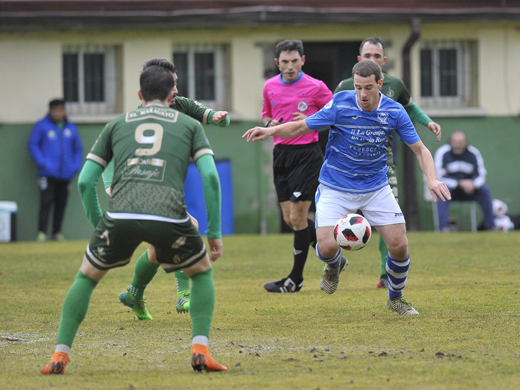 Gabi, rodeado de contrarios, intenta progresar con el balón controlado en un encuentro disputado por el CD La Granja ante el Astorga./ KAMARERO