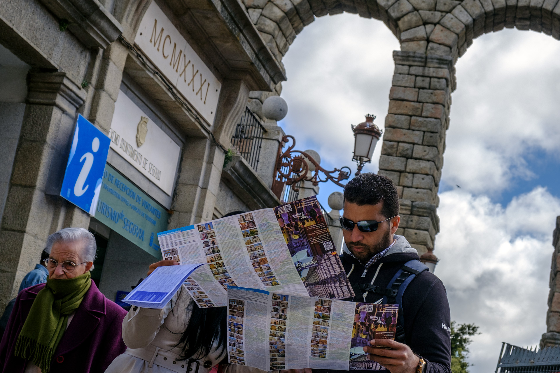 Una pareja de turistas ojea un mapa de la ciudad junto al Acueducto. / Kamarero