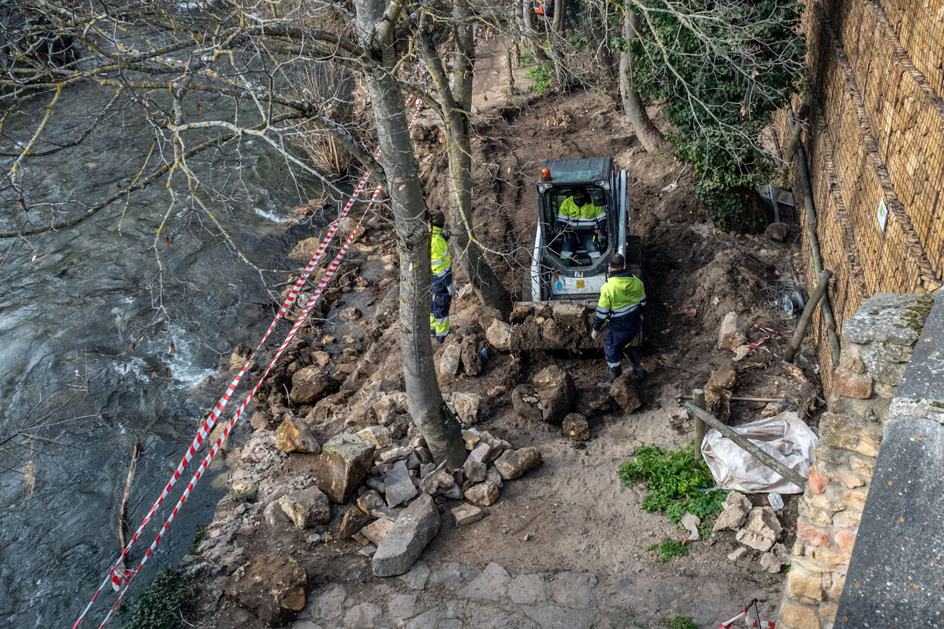 Trabajos para reponer el muro en el paseo que comienza bajo el puente de la Moneda. / Kamarero