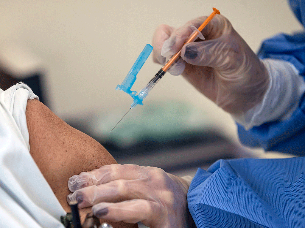 Una enfermera se dispone a administrar una vacuna a un residente de los centros de mayores. / EFE