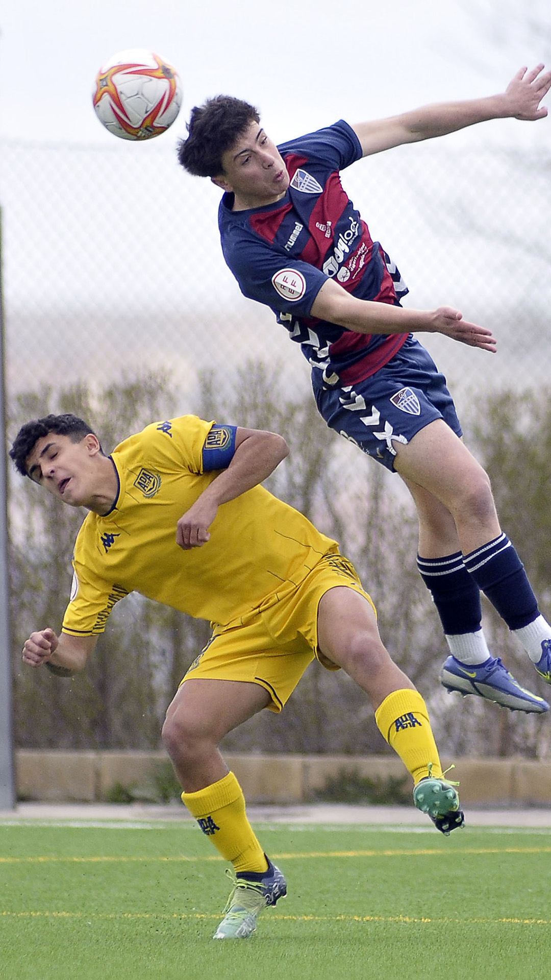 El jugador de la Segoviana salta por encima de su rival./ JUAN MARTÍN-G. SEGOVIANA