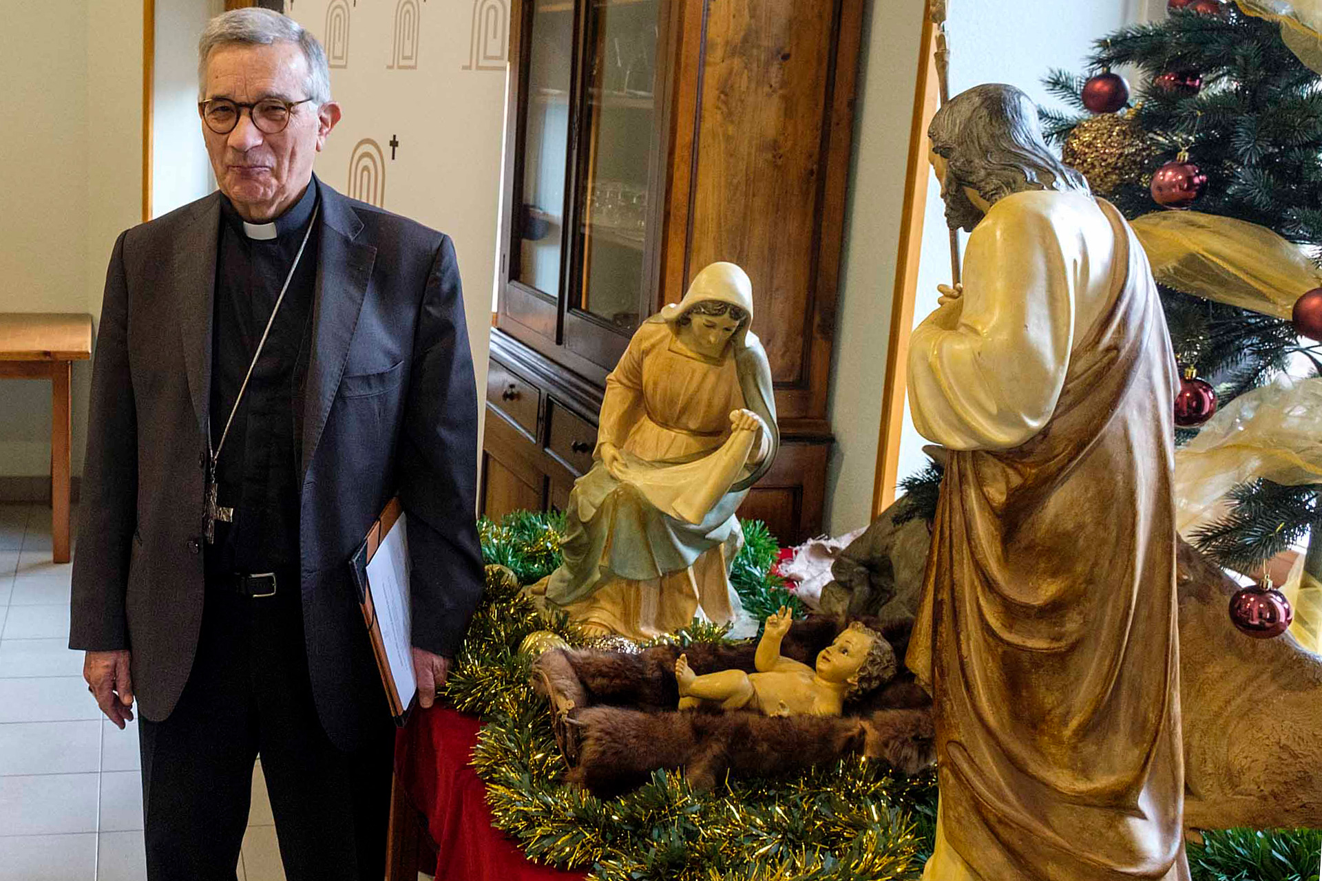 El obuspo, posa junto al Nacimiento instalado en uno de los comedores de la Casa de Espiritualidad./KAMARERO