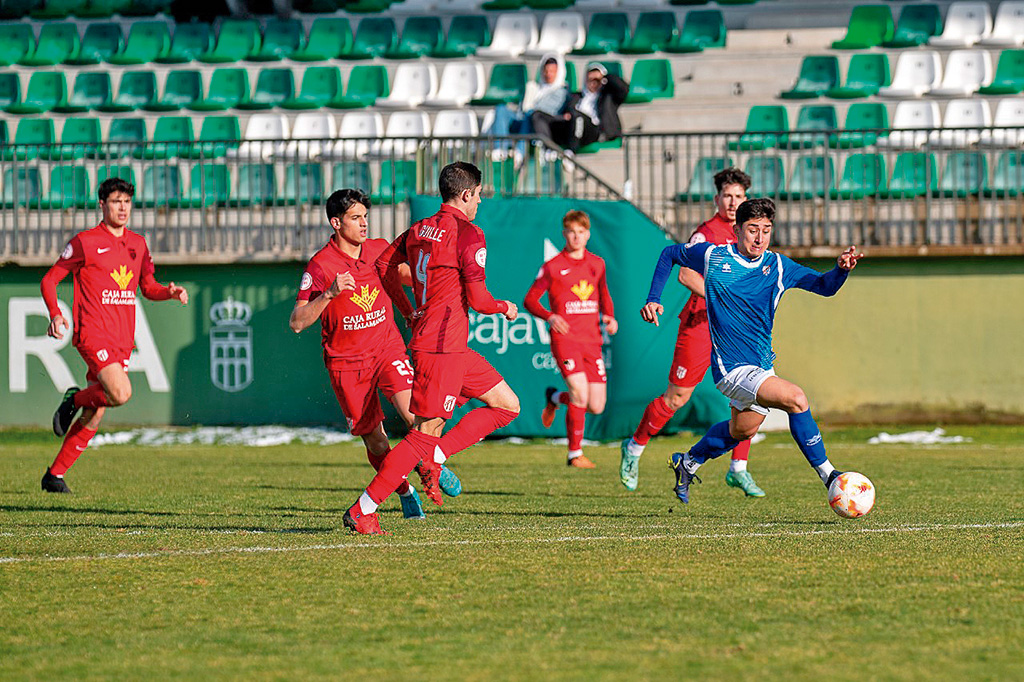 Beni corre  con el balón perseguido por varios rivales durante un partido del Unami./ LUIS HORCAJADA