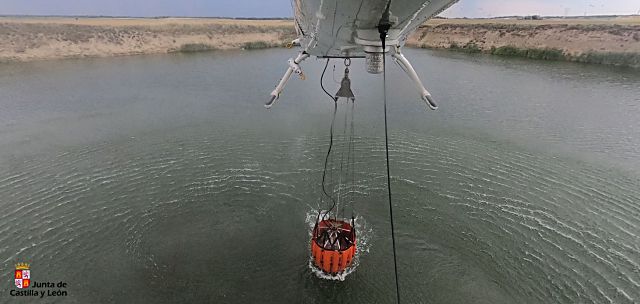 Maniobra de recarga de agua, el sábado en un punto de agua cercano al incendio de Montejo de Arévalo. / INFOCAL