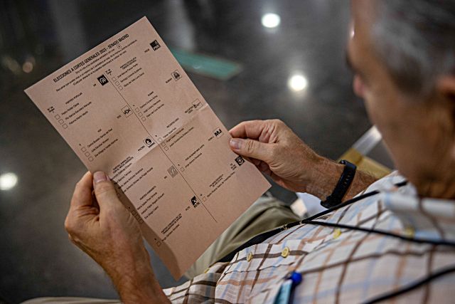 Un hombre observa una papeleta de los candidatos políticos al Senado de diferentes partidos, este jueves, último día para pedir el voto por correo, en una oficina de Correos de Madrid.  Correos abrirá todas las oficinas de la ciudad de Madrid y Barcelona así como las de los destinos más turísticos para facilitar la entrega de la documentación del voto por correo y su emisión, cuyo plazo finaliza el 20 de julio. EFE/ Daniel Gonzalez