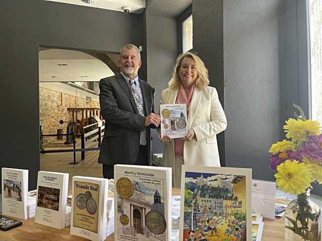 Glenn Murray y May Escobar posan con el libro.