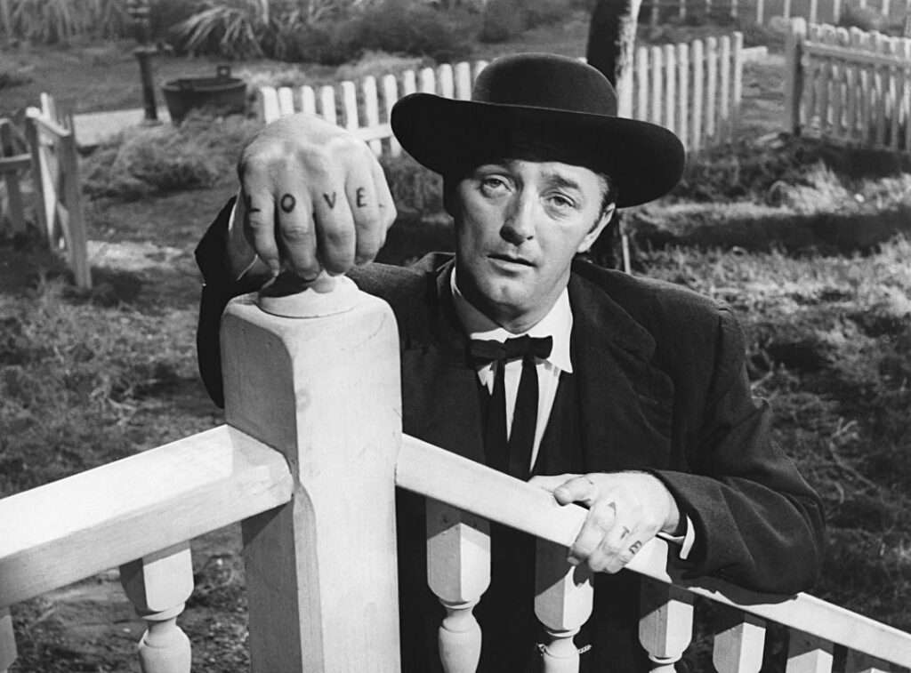 Fotograma de la película ‘La noche del cazador’ (1955) con Robert Mitchum. Fotograma de la película ‘La noche del cazador’ (1955) con Robert Mitchum.