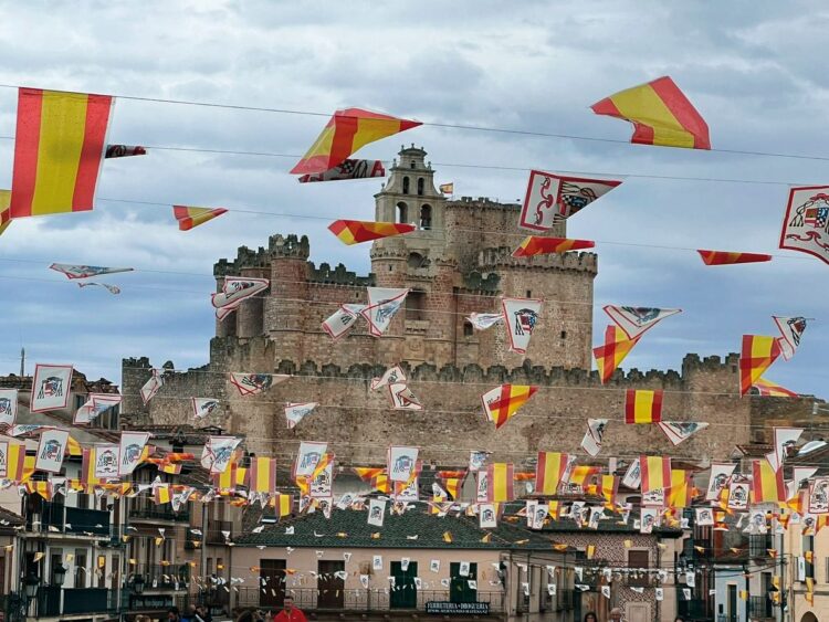 El castillo visto desde la plaza porticada adornada de banderolas. / Esther García Escudero